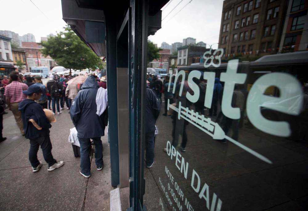 DARRYL DYCK / CANADIAN PRESS FILES
People gather outside supervised injection site, Insite, in the Downtown Eastside of Vancouver.