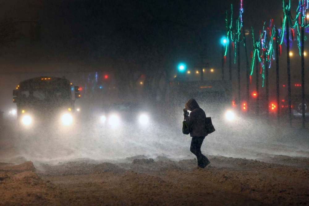 JOE BRYKSA / WINNIPEG FREE PRESS
A pedestrian scrambles across Portage Avenue and Edmonton Street in downtown Winnipeg. The city and southern Manitoba will have winter storm and possibly blizzard conditions for the day.