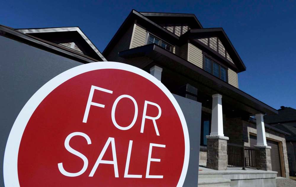 Sean Kilpatrick
/ The Canadian Press
A sign advertises a new home for sale in Carleton Place, Ont., on March 17, 2015. The head of the federal housing agency is raising a red flag about the state of Canada’s real estate sector, saying affordability concerns have spilled over from the country’s two most expensive cities to nearby markets.