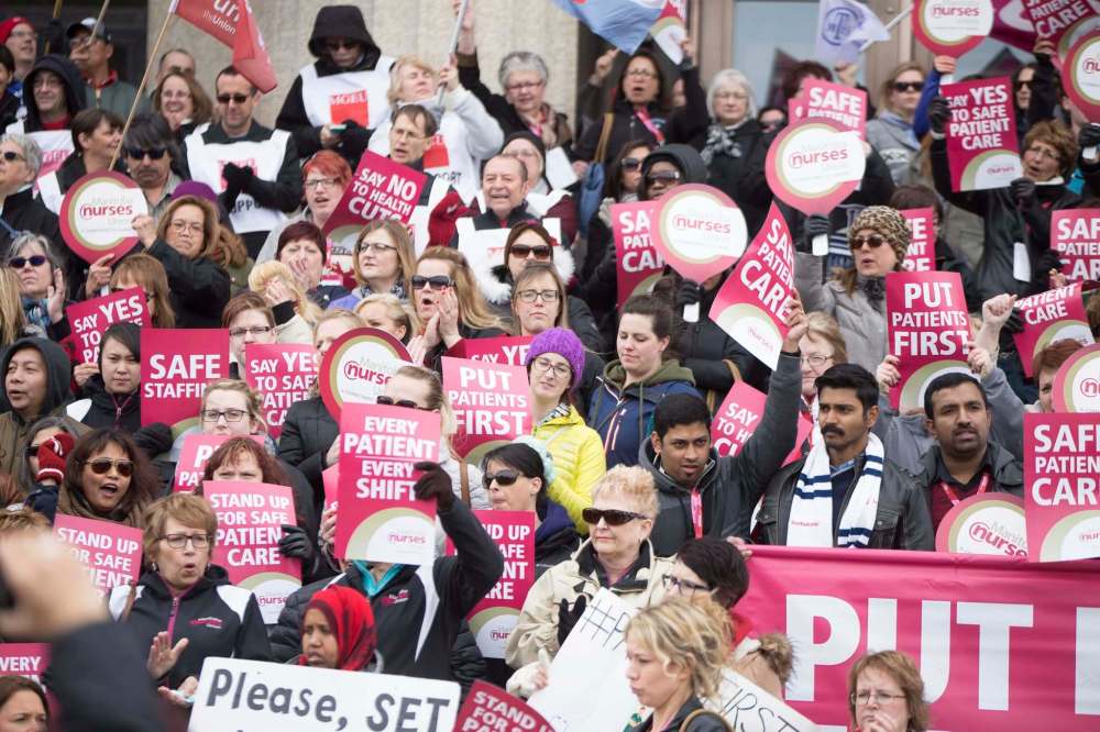 The noon-hour rally in front of the Manitoba Legislative Building was the largest and most boisterous protest yet against the hospital reorganization plan. (Jen Doerksen / Winnipeg Free Press)