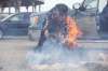 JEN DOERKSEN/WINNIPEG FREE PRESS
Elder Alma Kakikepinance transfers embers from a sacred fire started for McKay a couple days prior to the sacred fire at her vigil. Kakikepinace said bringing the embers has spiritual importance for the vigil.