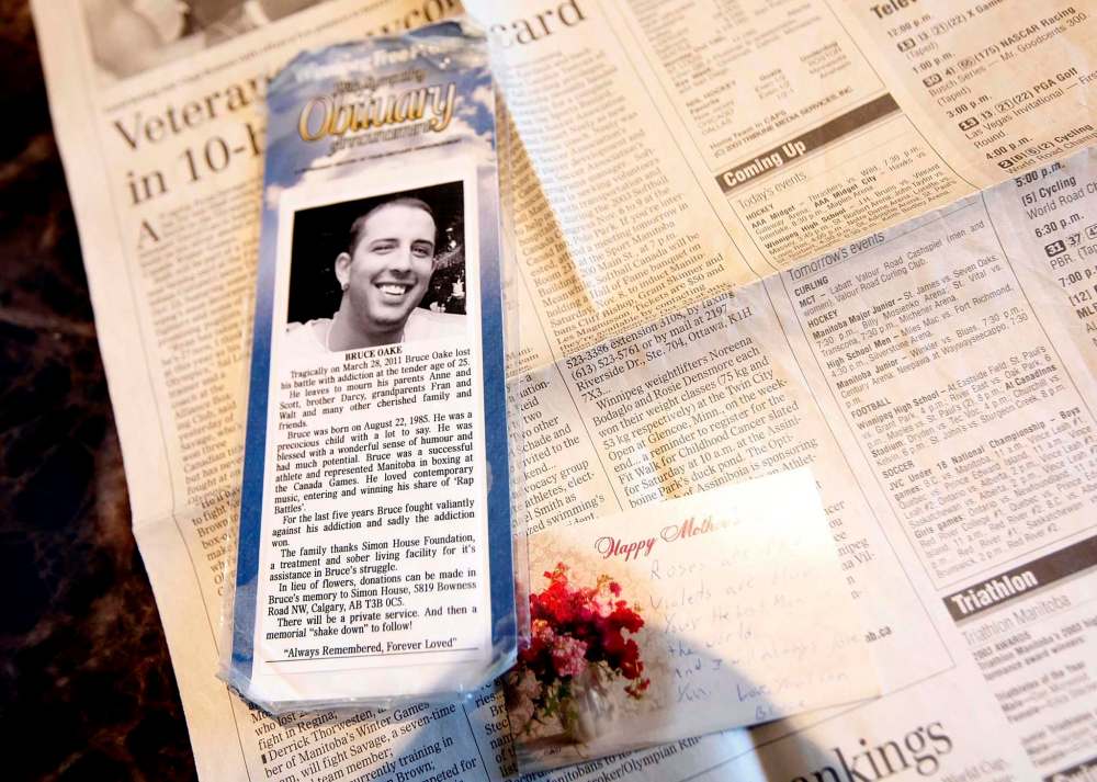 A bookmark with Bruce Oake's obituary is one of many pieces in his mother Anne's box of memorabilia. (Phil Hossack / Winnipeg Free Press)