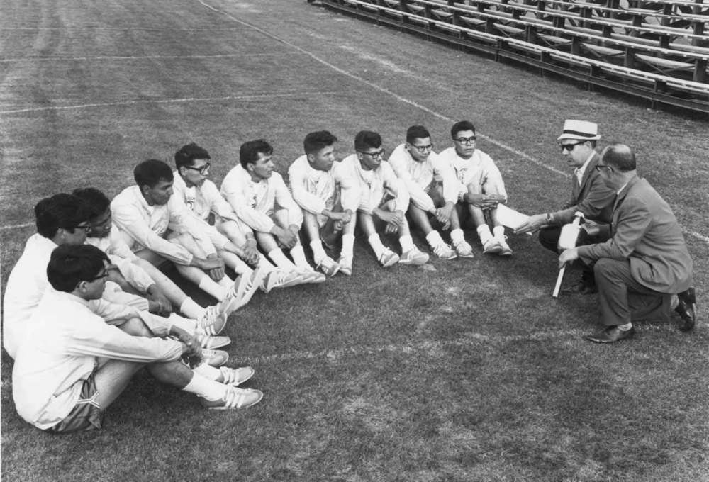 Aboriginal teenagers gather on the field at Winnipeg Stadium in this 1967 photo. Thirty-two years after the group relay-ran the Pan Am torch from St. Paul, Minn., to the gates of Winnipeg Stadium only to have a white athlete take the glory lap, seven of the survivors will finally complete the journey July 23. (Winnipeg Free Press)