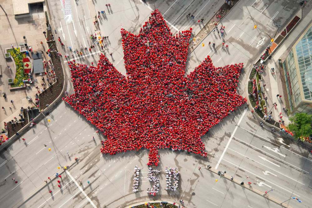 DAN HARPER PHOTO
Over 3,600 people gathered this moring at Portage and Main to create a living maple leaf.