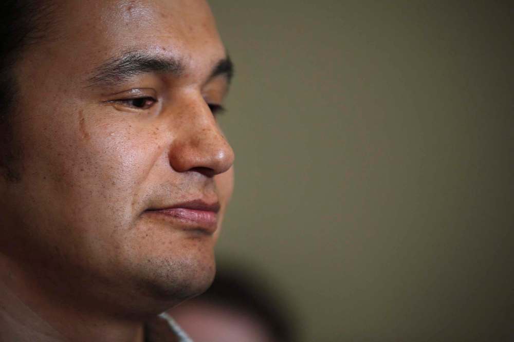 THE CANADIAN PRESS/John Woods
Wab Kinew, Manitoba NDP candidate for Fort Rouge, listens as Premier Greg Selinger responds at a news conference in Winnipeg, Friday, March 11, 2016. The woman at the centre of 14-year-old allegations of domestic violence against Manitoba NDP leadership candidate Wab Kinew says she was thrown across a room and left with rug burn on her legs.