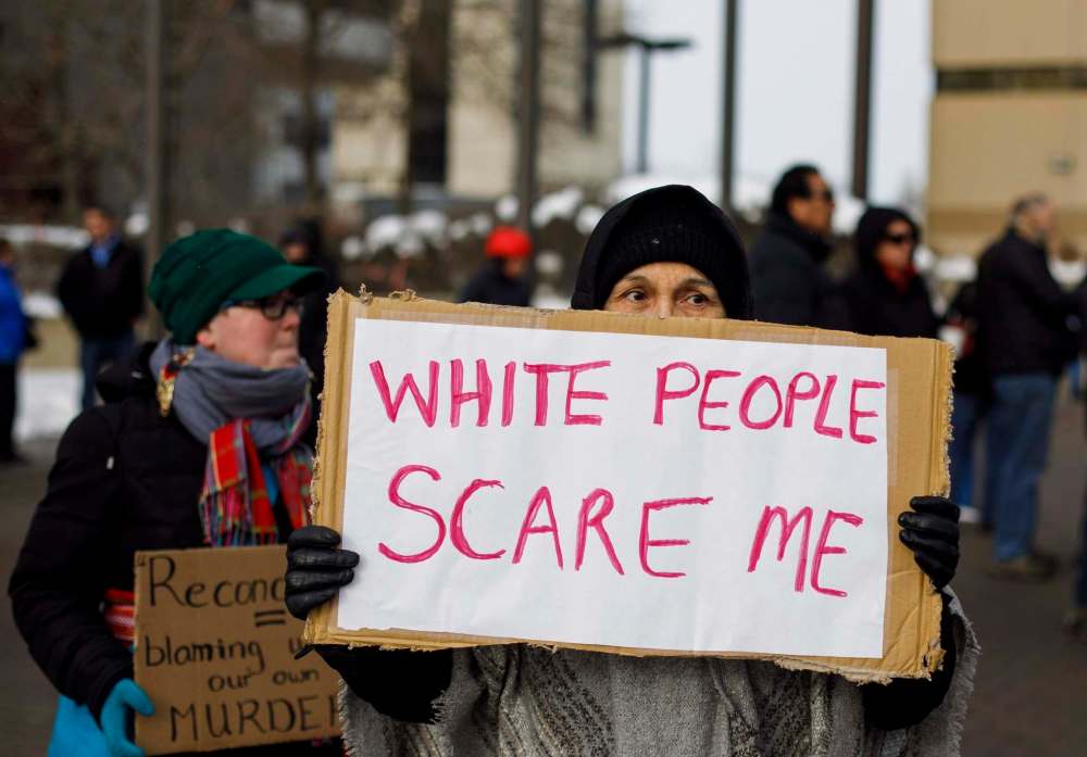 Jason Franson / THE CANADIAN PRESS
A woman in Edmonton holds a sign during a rally held Saturday in response to the acquittal of Gerald Stanley, who was on trial for the murder of Colten Boushie.