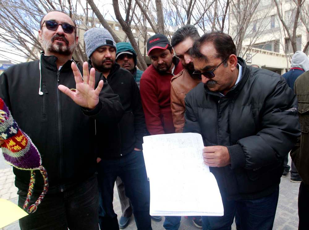 BORIS MINKEVICH / WINNIPEG FREE PRESS
Cab driver Bhupendar Singh, left and Unicity Taxi driver Mukhtar Husain Lang with a book of signatures from protesting cabbies.