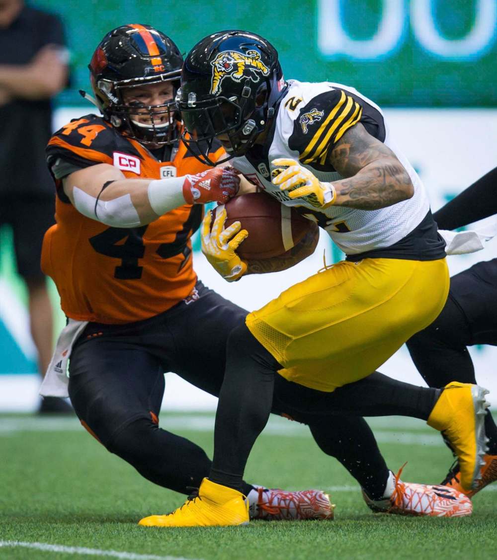 DARRYL DYCK / THE CANADIAN PRESS FILES
Adam Bighill, left, tackles Hamilton Tiger-Cats' Chad Owens during a CFL football game between the B.C. Lions and Tiger-Cats in Vancouver, August 13, 2016. The addition of Bighill is a major boost to the Bombers' linebackers group.