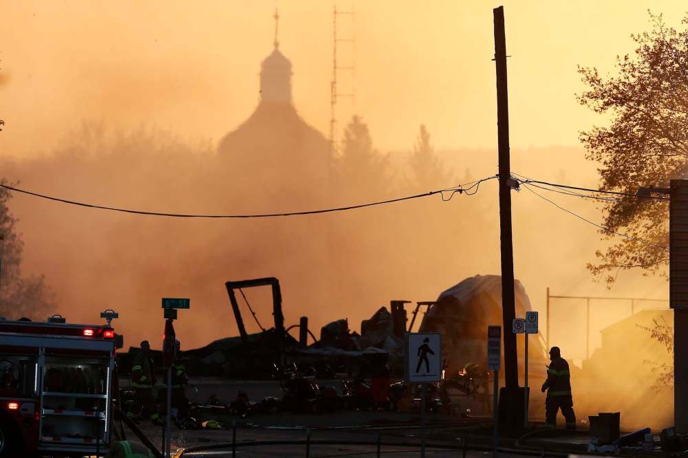 JOHN WOODS / THE CANADIAN PRESS
Firefighters work to extinguish fires in downtown buildings in Brandon, Manitoba Saturday, May 19, 2018.A blaze that Premier Brian Pallister called