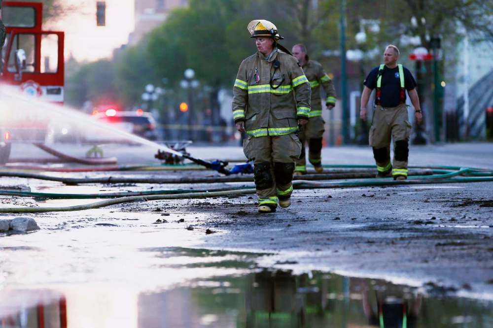 JOHN WOODS / THE CANADIAN PRESS
Firefighters work to extinguish fires in downtown buildings in Brandon, Manitoba Saturday, May 19, 2018. A blaze that Premier Brian Pallister called