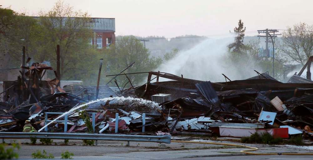 JOHN WOODS / THE CANADIAN PRESS
Firefighters work to extinguish fires in downtown buildings in Brandon, Manitoba Saturday, May 19, 2018. A blaze that Premier Brian Pallister called