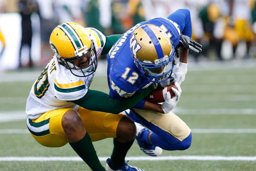 THE CANADIAN PRESS/John Woods
Bowman snags a touchdown pass against the Edmonton Eskimos during the first half of a pre-season CFL game in Winnipeg on Friday. At 6-foot-3, Bowman presents a formidable target for quarterback Matt Nichols and a difficult coverage assignment for defensive backs.