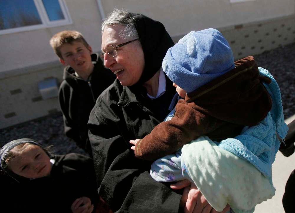 PHIL HOSSACK / Winnipeg Free Press
Lena Hofer cradles her grandson Christopher while interacting with some of the young people at their James Valley Hutterite Colony home.
