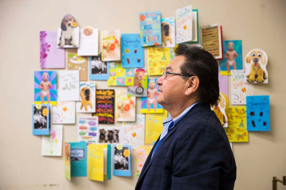 Cross Lake councillor Donnie McKay in front of a sampling birthday cards for the health minister from people from Cross Lake who are yearning for provincial funds to help build a health complex . (MIKAELA MACKENZIE / WINNIPEG FREE PRESS)