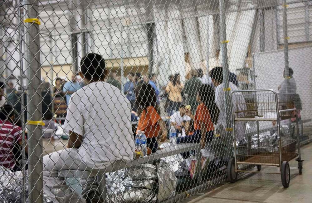 U.S. Customs and Border Protection / The Associated Press
People who were taken into custody in cases of illegal entry into the United States, sit in one of the cages at a facility in McAllen, Texas.