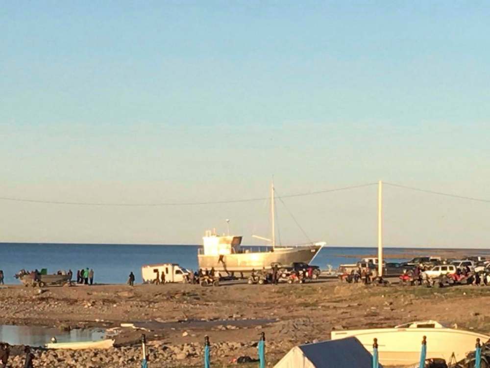 GORDY KIDLAPIK / TWITTER
Residents from the town of Arviat wait along the shore for the body of Aaron Gibbons, 31, who died Tuesday on Sentry Island, 10 kilometres from the town which is on the western shore of Hudson Bay. Gibbons was killed by a polar bear.