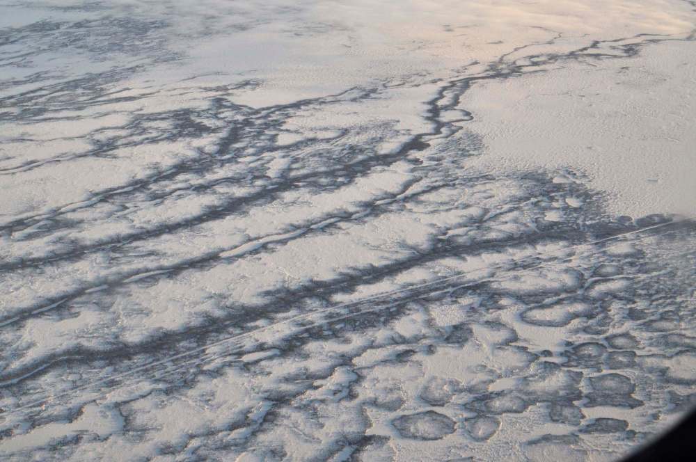 A section of the Hudson Bay Railway is seen from the window of a propeller plane, somewhere between Churchill and Gillam, alongside part of the ice trail crafted by Polar Industries, to transport goods along the route in December, 2017. (Dylan Robertson / Winnipeg Free Press Files)