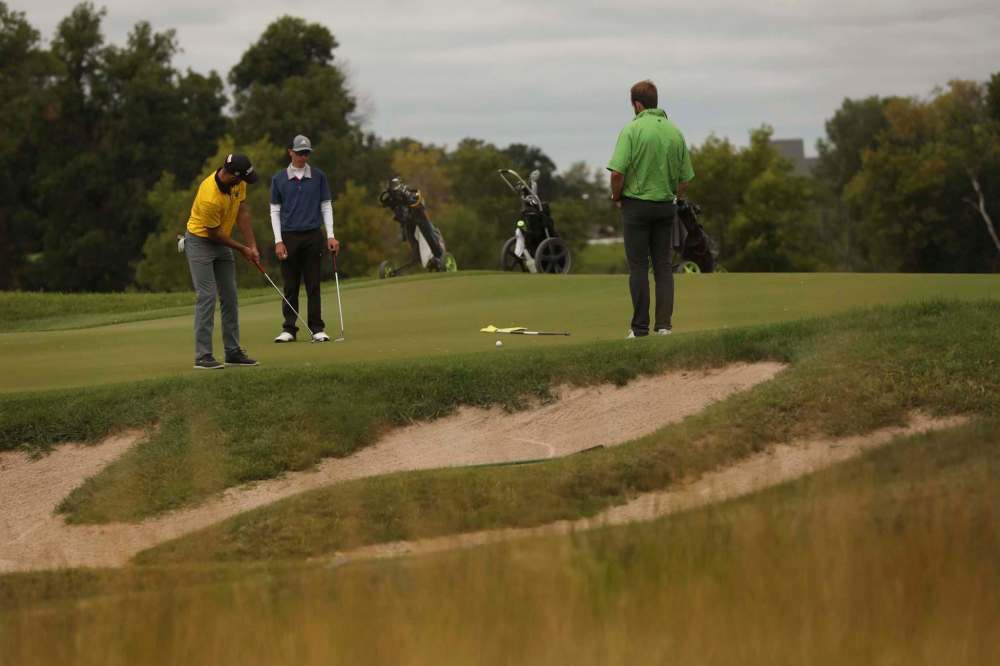 Connor Stewart makes his putt on the 17th green while golfing with his friends at the Southwood Golf & Country Club Wednesday.
