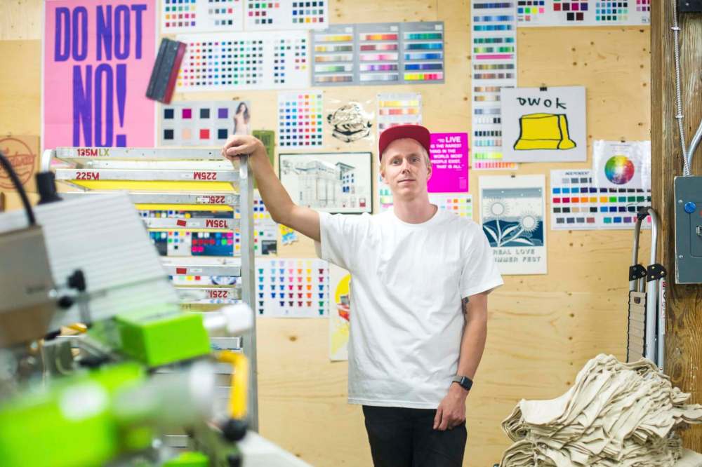Photos by MIKAELA MACKENZIE / WINNIPEG FREE PRESS
Owner of the Floodway Print Co. Cory Beal in the company’s new space in the Glengarry Block, a 108-year-old warehouse that was once at the centre of Winnipeg’s ‘schmatta business.’