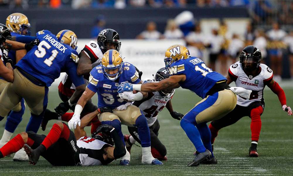 PHIL HOSSACK / WINNIPEG FREE PRESS -
Winnipeg Blue Bomber #33 Andrew Harris scrambles through the line of scrimmage.