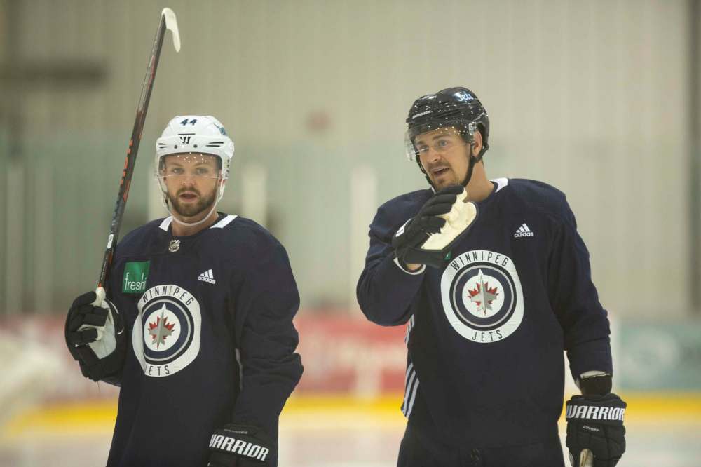 Josh Morrissey (left) and Mark Scheifele skate together Tuesday at the Bell MTS Iceplex. (Andrew Ryan / Winnipeg Free Press)