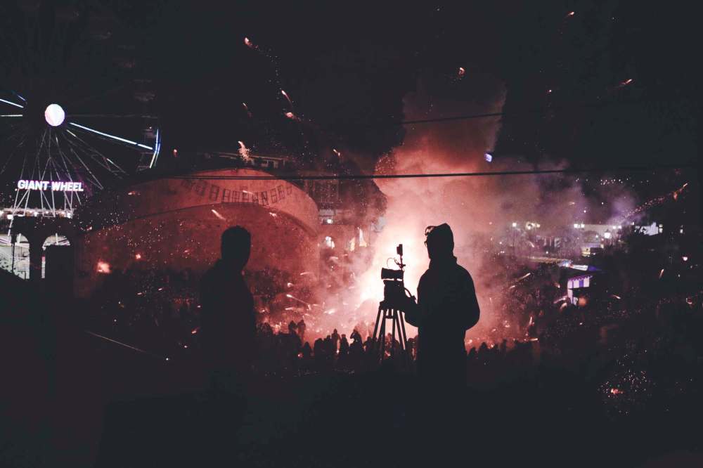 Brimstone & Glory's film crew shoots the Burning of the Bulls explosions from above street level. (Oscilloscope)