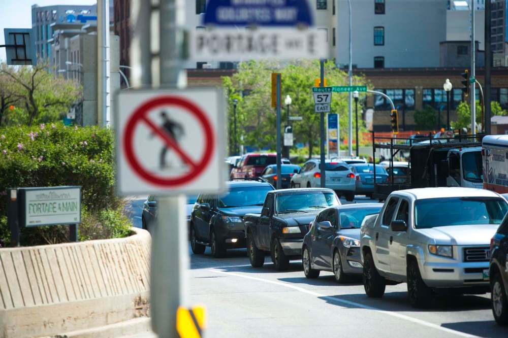 Pedestrians have not been allowed to cross Portage Avenue and Main Street since barricades were erected at the intersection in 1979. (Mikaela MacKenzie / Winnipeg Free Press)