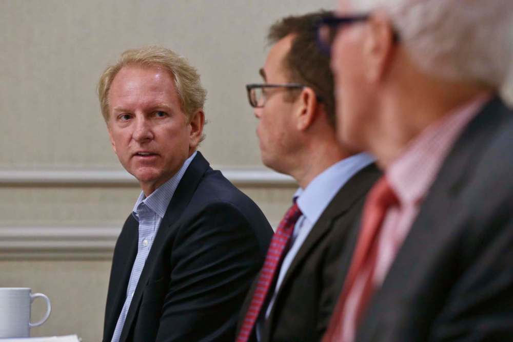 MIKE DEAL / WINNIPEG FREE PRESSAndrew Marquess one of the landowners of the Parker Lands Fulton Grove development project turns to lawyers, Kevin Toyne (centre) and Dave Hill (right), during the announcement that they have filed a lawsuit against the city of Winnipeg and several senior administrators. 181016 - Tuesday, October 16, 2018