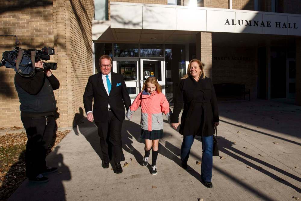 Jenny Motkaluk voted with her husband, Trevor Sprague, and daughter, Emily Motkaluk-Sprague, at St. Mary’s Academy Wednesday morning. (Mike Deal / Winnipeg Free Press)