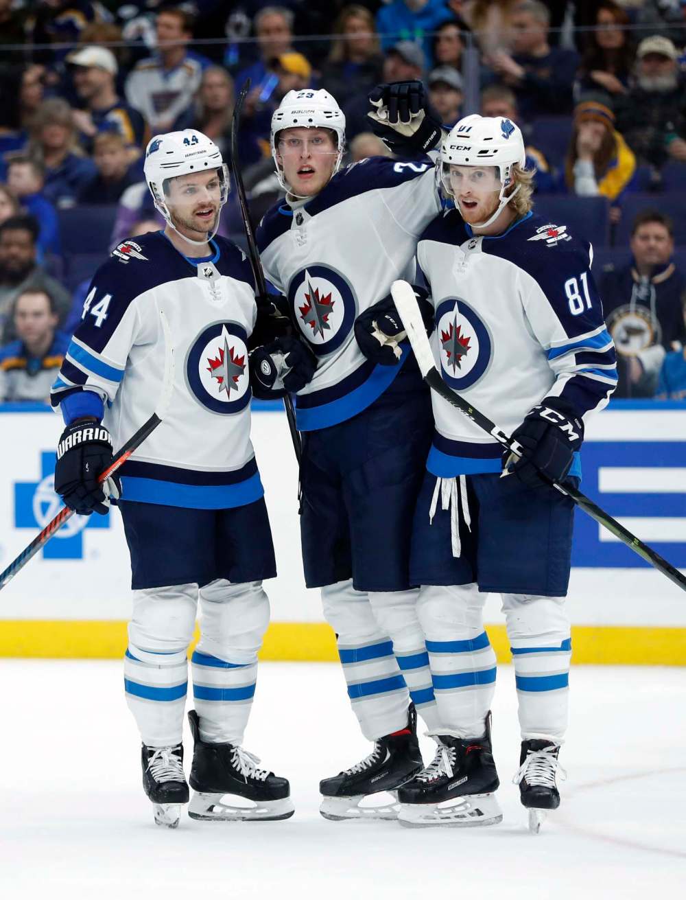 Patrik Laine, with Josh Morrissey (left) and Kyle Connor, is a goal shy of scoring 100 in his career. (Jeff Roberson / The Associated Press files)