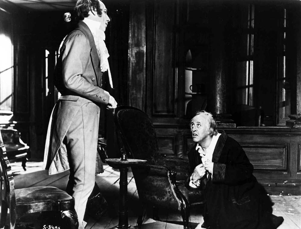 Ebenezer Scrooge (Alastair Sim) cowers before the spirit of Jacob Marley (Michael Hordern) in a scene from the 1951 movie A Christmas Carol.