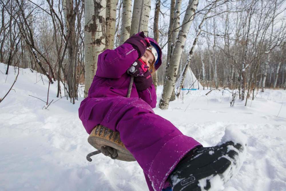 Mike Deal / Winnipeg Free Press
Tessa, 4, takes a turn on a rope swing during self-directed play outdoors Monday morning at the FortWhyte Alive Forest School.