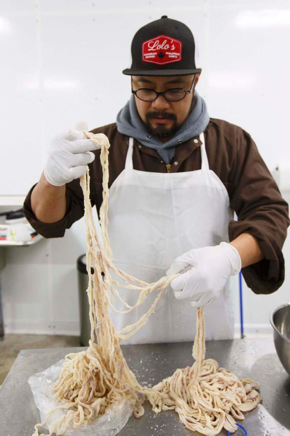 PHOTOS BY MIKE DEAL / WINNIPEG FREE PRESS 
Lord Sale sorts through a package of natural hog casings in preparation for making chavacano sausages.