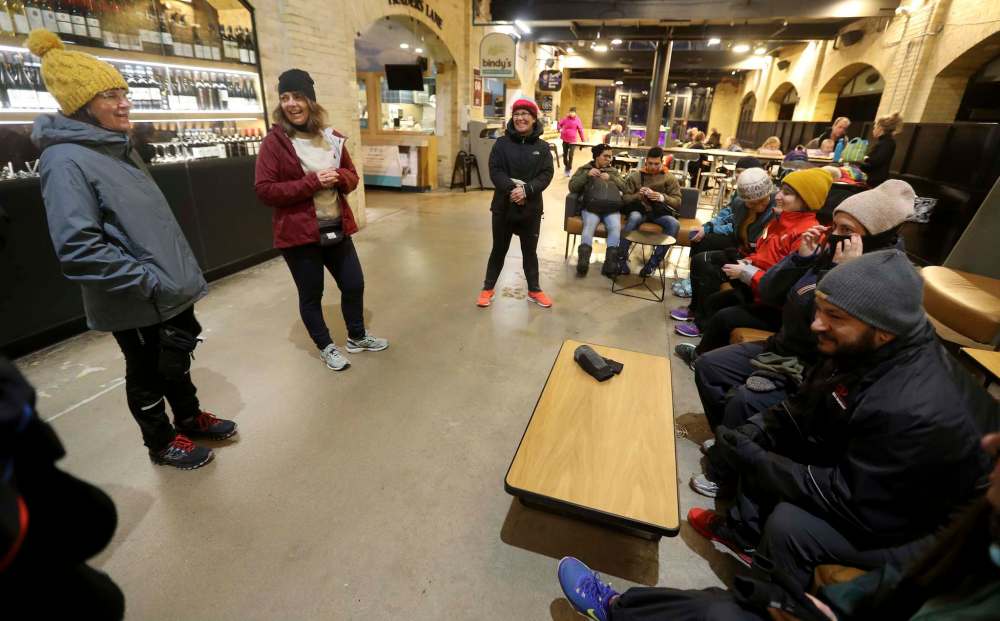 Somers and the members of a run club prep to brave the ourdoor elements. (Trevor Hagan / Winnipeg Free Press)