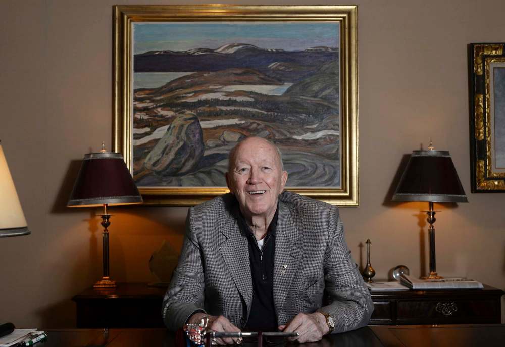 Jim Burns in front of a Group of Seven painting (Iron Ore Country Labrador, 1938) in his office in 2014. (Sarah Taylor / Free Press files)