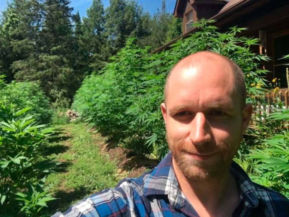 Mark Spear, founder and CEO of Burnstown Farms Cannabis Company, poses with outdoor cannabis plants in his personal medical cannabis garden. (Supplied)