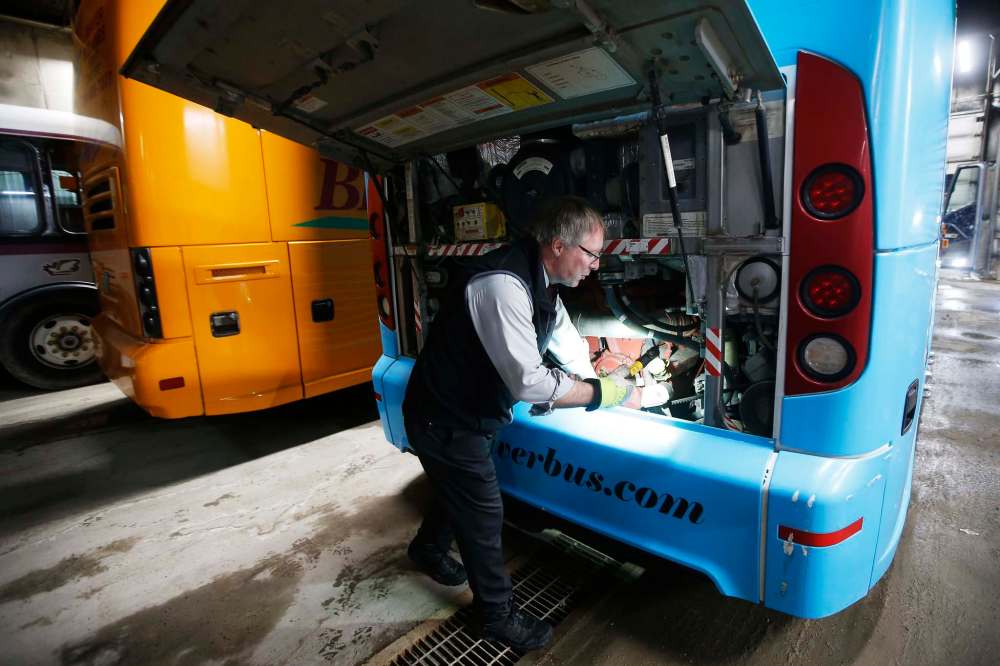JOHN WOODS / WINNIPEG FREE PRESS
Hamelin inspects his bus that he will drive to Waywayseecappo.