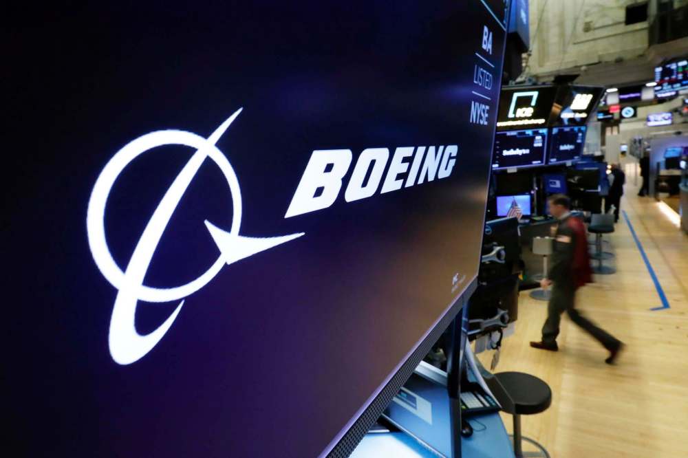 The Boeing logo appears above a trading post on the floor of the New York Stock Exchange. Shares in the aircraft maker fell Tuesday amid safety concerns following another deadly crash involving its most popular plane. (Richard Drew / The Associated Press)