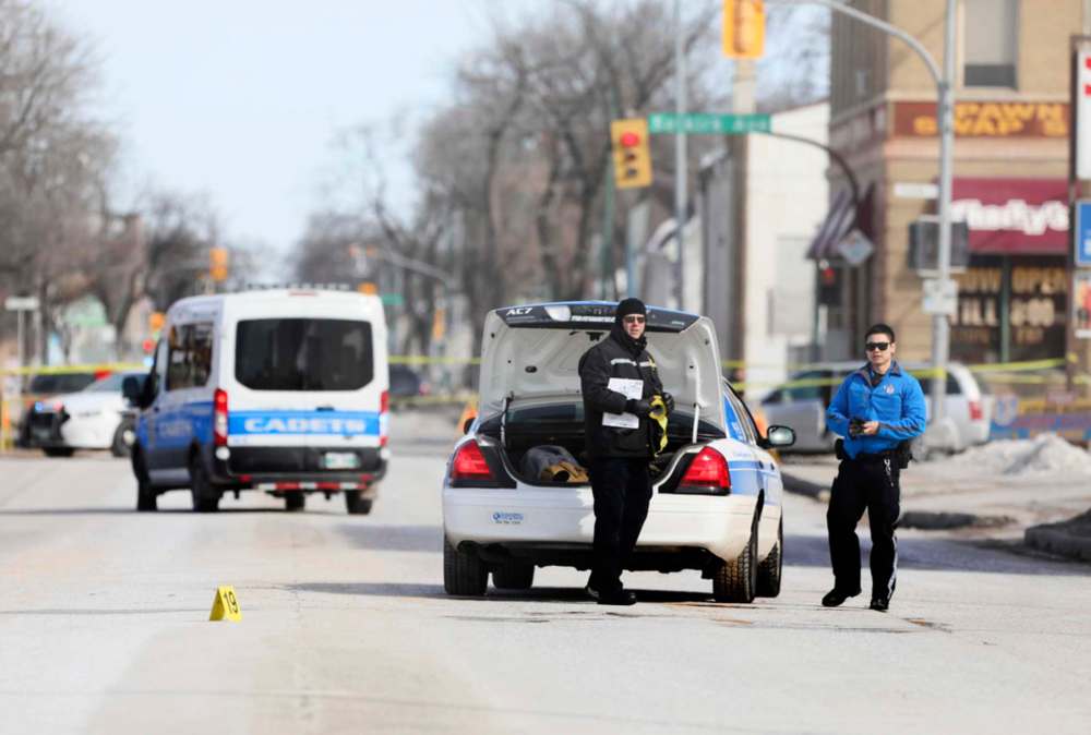 Forensic investigators and cadet units secure the area around Salter Street and Selkirk Avenue Saturday morning while investigating Winnipeg's ninth homicide. (Ruth Bonneville / Winnipeg Free Press)