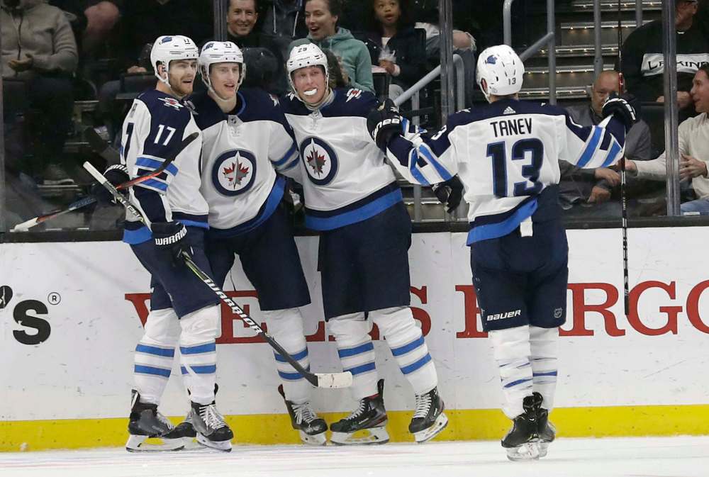 Myers, second from left, celebrates his goal with teammates Adam Lowry, left, Patrik Laine, centre, and Brandon Tanev during the game against the Los Angeles Kings Monday. (Jose Sanchez / The Associated Press)