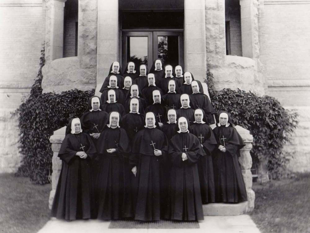 SUPPLIED
Sisters of the Holy Names of Jesus and Mary on the front steps of St Mary’s Academy in 1915.