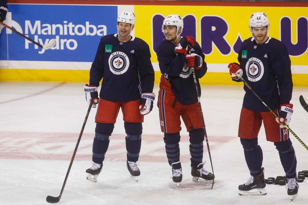 From left: Matt Hendricks, Brandon Tanev and Adam Lowry during a pre-game skate in February at Bell MTS Place. (Mike Deal / Free Press files)