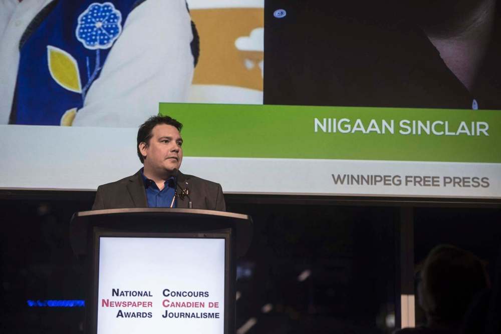 Tijana Martin / The Canadian Press
Free Press writer Niigaan Sinclair accepts the award for top newspaper columnist in the country Friday night at the National Newspaper Awards in Toronto.