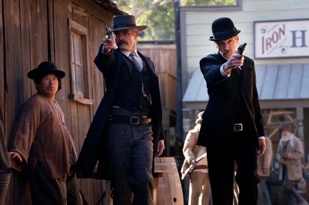 Seth Bullock (Timothy Olyphant, left) and Sol Star (John Hawkes) come out guns ablazing in Deadwood: The Movie.