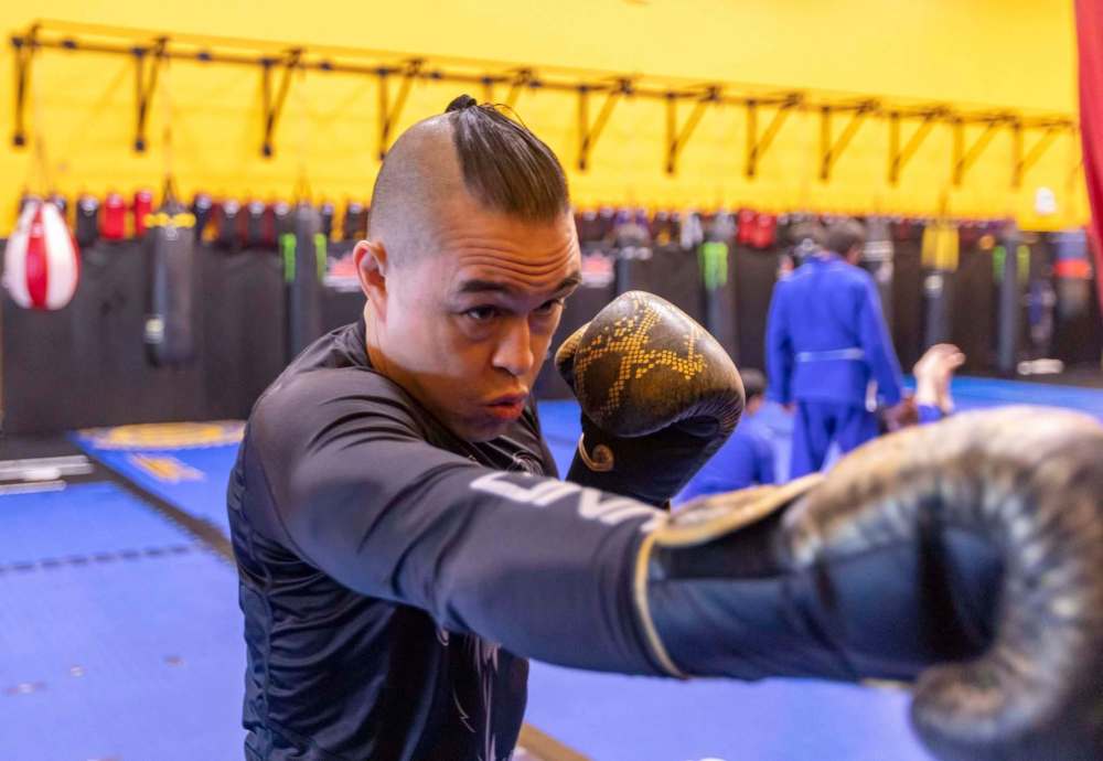 Pang warms up by hitting a punching bag.
