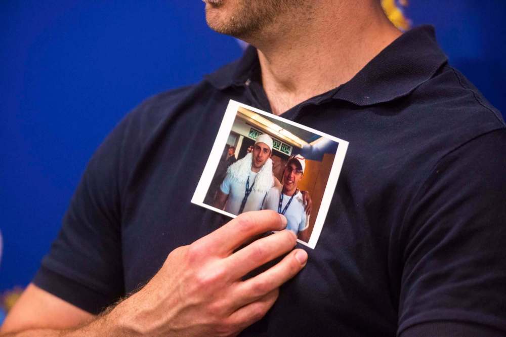 MIKAELA MACKENZIE / WINNIPEG FREE PRESS
Michael Silicz holds a picture of him and his brother, Justin Silicz, at a media briefing eariler this month.