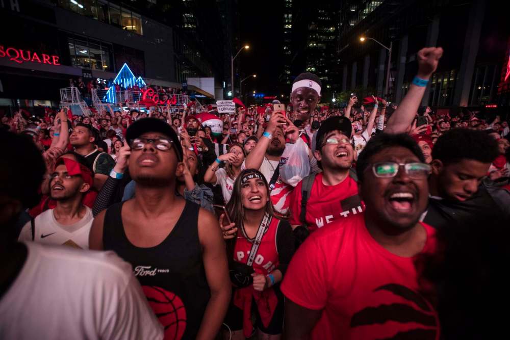 TIJANA MARTIN / THE CANADIAN PRESS
Fans celebrate from the Jurassic Park fanzone outside of Scotiabank Arena in Toronto on Friday.