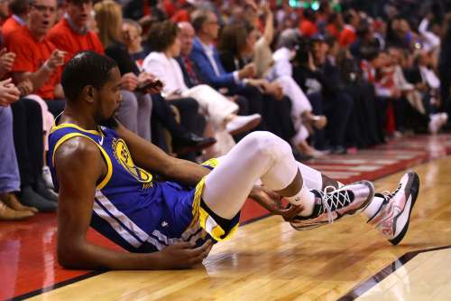 Kevin Durant reacts after sustaining an injury during the second quarter against the Toronto Raptors Monday night. (Gregory Shamus / Getty Images /TNS)