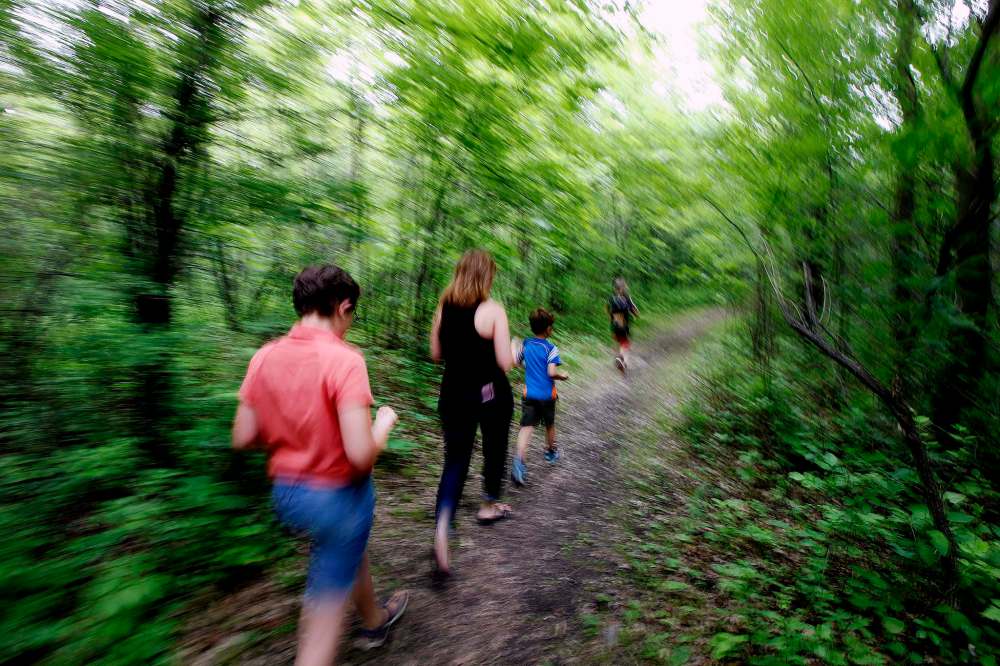 PHIL HOSSACK / WINNIPEG FREE PRESS
Brynn (from left), Lorna, Rylan and Grayson Kroeker look for hiding spots at St. Vital Park.