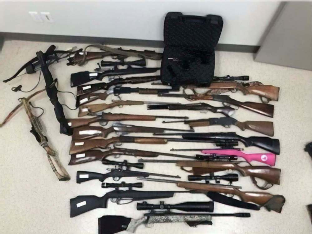 On June 21 Manitoba First Nations Police Service seized 14 rifles, 2 shotguns, 2 crossbows, a 9mm handgun, a .22-calibre revolver and several edged weapons from a home on Swan Lake First Nation. (Supplied photo)